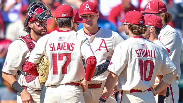 Pitching coach Matt Hobbs and pitcher Dylan Carter with the infield against Tennessee on Sunday.